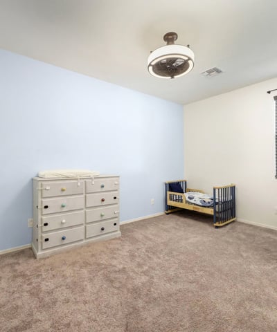 Flexible bedroom with tile floors and ceiling fan, suitable for a bedroom, home gym, or creative workspace.