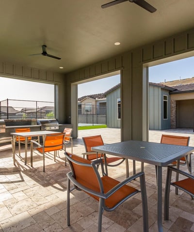 Shaded pavilion featuring seating and grilling stations, providing a comfortable outdoor space for residents to gather and entertain.