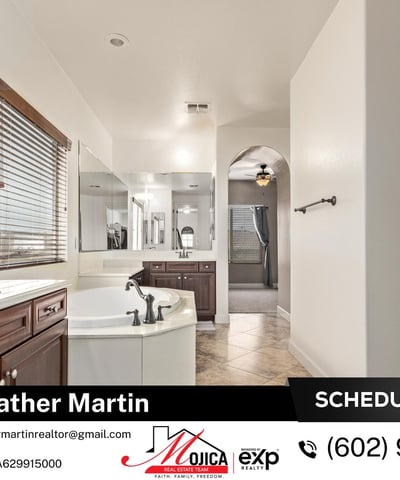 Unwind in the oversized soaking tub surrounded by extended counter space and dual sinks. A spa-like feature within this Glendale property offering modern updates and energy-efficient living.