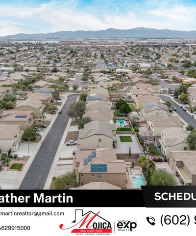 This elevated aerial image highlights the rooftop solar system and fenced backyard pool. Surrounded by desert landscaping, this Glendale home combines energy-efficient upgrades with outdoor entertaining space.