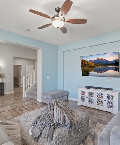 View from the living room toward the open entryway, showcasing the spacious layout, tall ceilings, and modern finishes throughout the home.