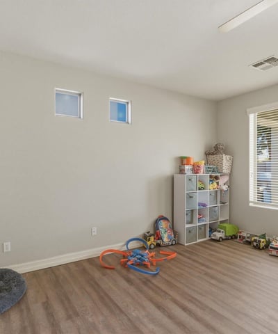 Spacious bonus room with wood-style flooring and natural light, offering flexible space for a playroom, office, or additional living area.