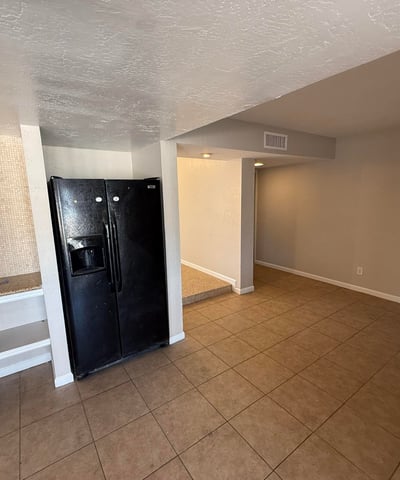 Kitchen and dining area with tile floors and smooth flow to surrounding living spaces. The open layout makes everyday meals and gatherings easy in this Glendale home.