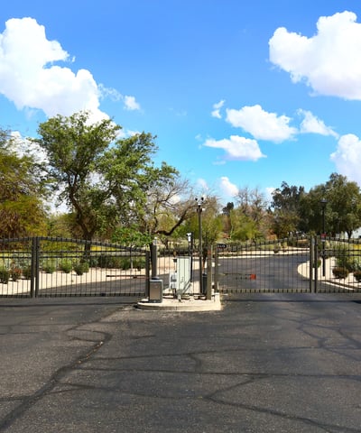 Entrance to The Fairways community featuring gated access and landscaped surroundings. This Phoenix neighborhood offers privacy and a desirable golf course setting.