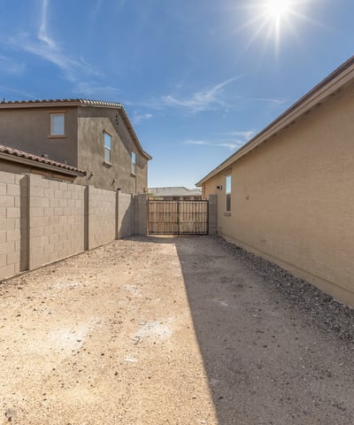 Convenient side yard access with RV gate, providing space for parking, storage, or recreational vehicle use.
