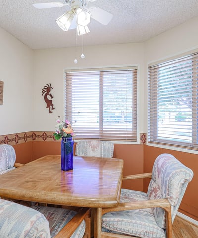 Bright breakfast nook with large windows, warm tones, and cozy seating perfect for casual dining and morning gatherings.