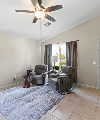 Bright and airy living room featuring large windows, neutral colors, and comfortable layout for everyday living.