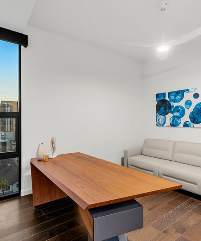 Contemporary room ideal for remote work or guest accommodations, with clean design, updated flooring, and bright Phoenix views.