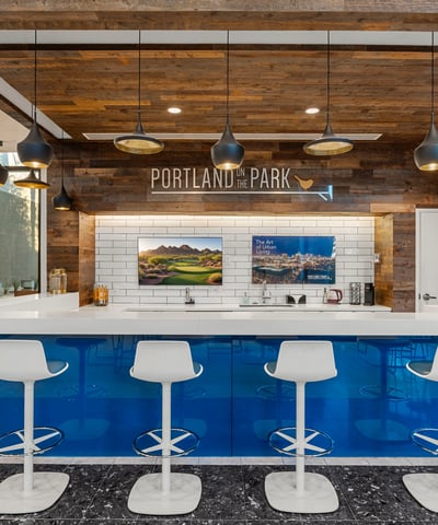 Chic bar lounge with wood accents, updated finishes, and seating for guests, perfect for socializing in Phoenix.