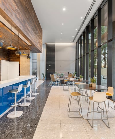 Light-filled lobby featuring expansive glass walls and contemporary furnishings, enhancing the modern feel of this Phoenix property.