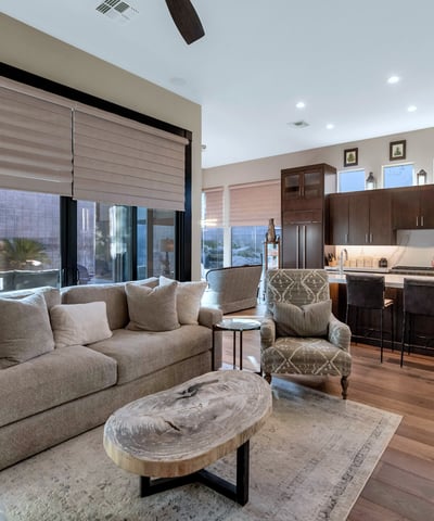 Flowing layout connecting living, dining, and kitchen spaces with abundant natural light ideal for entertaining in this Phoenix property.