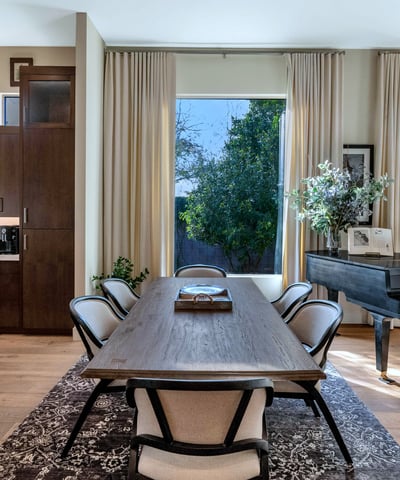 Sunlit dining room with expansive windows and easy access to the kitchen, ideal for gatherings in this Phoenix residence.