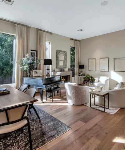 Flowing layout connecting dining and living spaces with modern finishes and warm wood flooring in this Phoenix property.