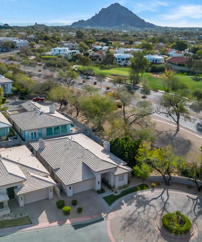Aerial view showcasing a peaceful cul-de-sac with attractive homes, landscaped streets, and convenient access to main roads in Phoenix.