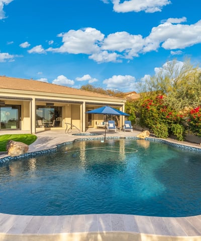 Scottsdale outdoor space featuring pool, spa, and lush landscaping, creating a resort-style backyard retreat.
