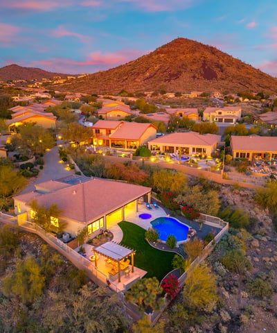 Scottsdale aerial showcasing the elevated homesite, resort-style backyard, and panoramic desert and mountain views.