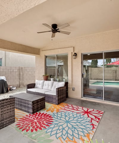 Outdoor living space with covered patio and seating area, perfect for relaxing or hosting. Easy access to the pool enhances the Casa Grande lifestyle.