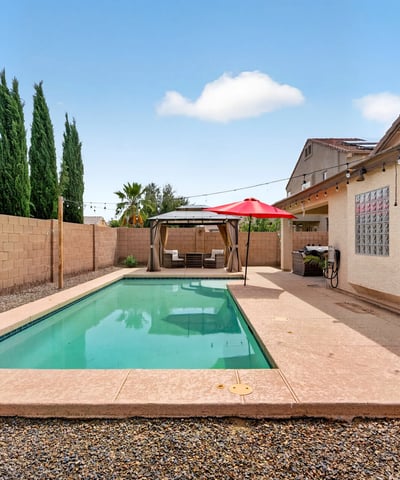 Inviting backyard with pool and low-maintenance design. Perfect for cooling off and entertaining in this Casa Grande home.