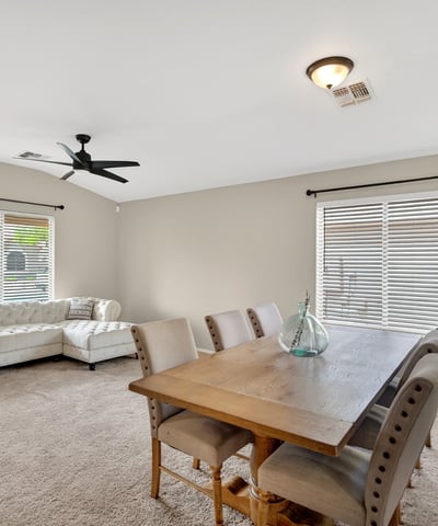 Dining area with large windows and inviting atmosphere. Ideal for gatherings and everyday meals in this Casa Grande home.