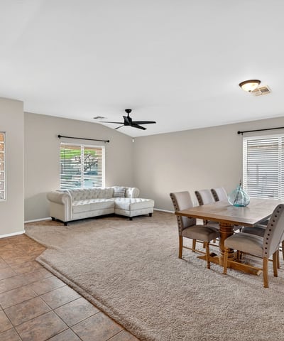 Large living and dining space with high ceilings and natural light. Flexible layout supports entertaining and comfortable living in Casa Grande.