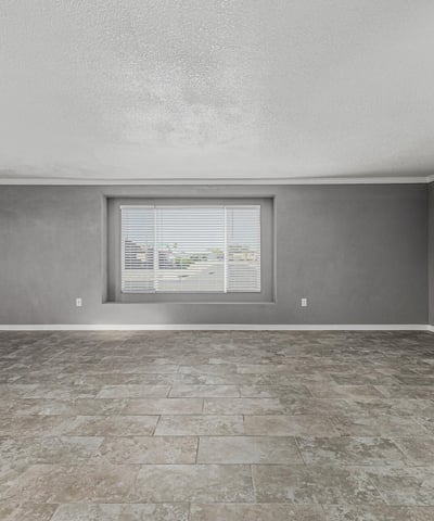 Light-filled living room with updated flooring and large window. This Sun City home offers a clean, modern feel with move-in ready convenience.