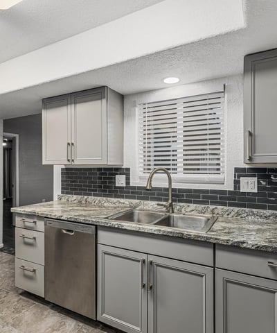 Updated kitchen with granite countertops, modern cabinetry, and sleek finishes. This Sun City home delivers both style and functionality.