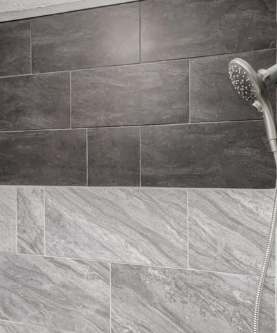 Modern shower with dual shower heads and custom tile detail. This Sun City home provides spa-inspired upgrades and elegant finishes.