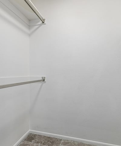 Generous walk-in closet with organized hanging space. This Sun City home includes practical storage and well-designed interiors.