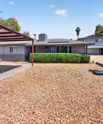 Durable paver parking under a covered structure provides style and practicality for this upgraded Phoenix multi-unit property.