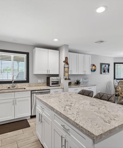Open kitchen flowing into dining area with updated cabinetry, modern finishes, and natural light enhancing the space.