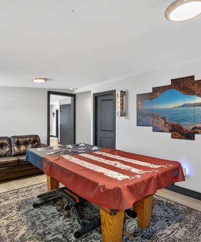 Comfortable lounge area paired with game space, showcasing the flexibility and livability of this remodeled Phoenix property.
