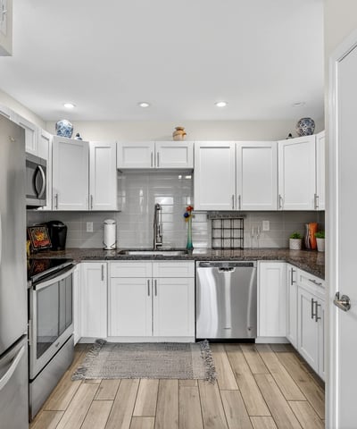 Contemporary kitchen in Scottsdale with stainless appliances, white cabinets, and tile backsplash offering both style and functionality.