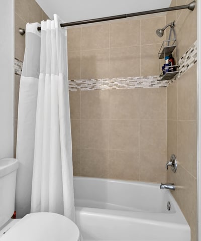Scottsdale bathroom showcasing tiled shower walls, accent detailing, and functional layout for comfortable daily use.