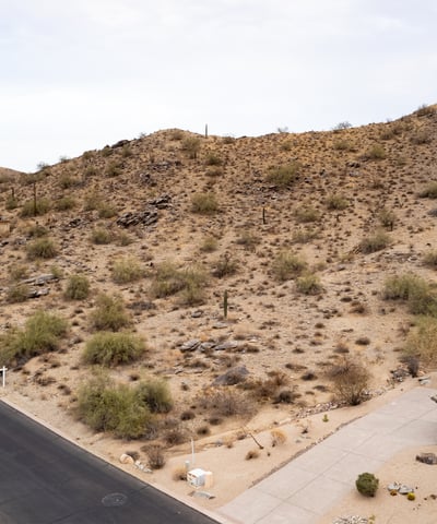 Expansive desert hillside lot offering panoramic mountain scenery and surrounding luxury homes. Located in Phoenix, this elevated property provides the ideal setting for a private custom retreat.