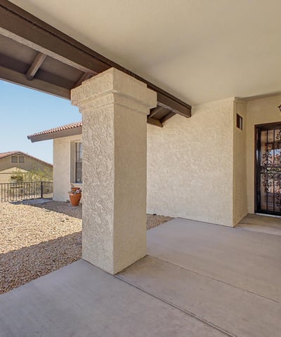 A shaded front porch and decorative gated entry create a warm and inviting arrival experience. This attractive outdoor space adds character while enhancing the home's curb appeal and functionality.