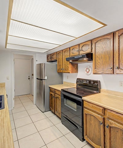 Enjoy a functional kitchen with extensive storage, ample countertops, and natural light from the window above the sink. The efficient design supports comfortable daily living while maintaining a warm, welcoming feel.