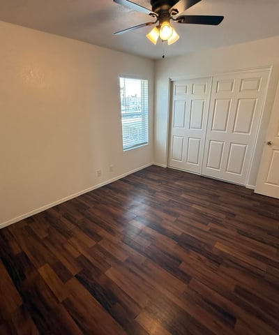 Spacious bedroom featuring a large closet, neutral finishes, and durable flooring. The room's generous proportions create a comfortable setting for a variety of furniture configurations.
