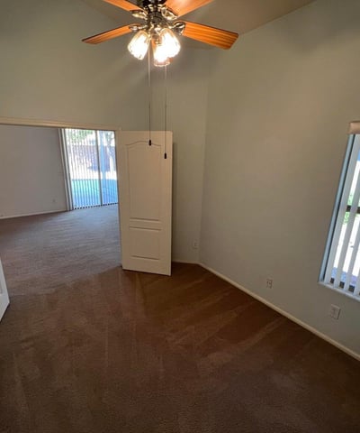 Light-filled den with a functional layout and neutral finishes, offering endless possibilities for work, study, entertainment, or guest accommodations within this thoughtfully designed home.