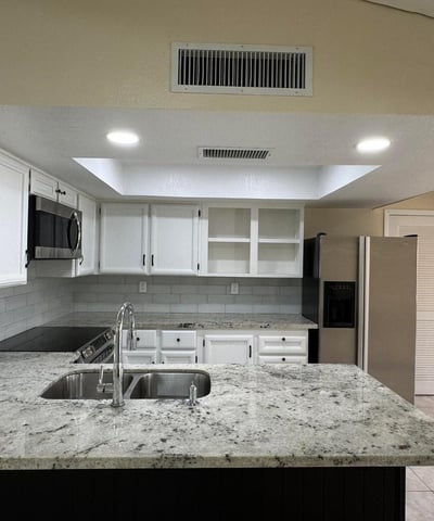 Beautifully updated kitchen with granite counters, recessed lighting, and seamless access to the main living area. Perfect for hosting family and friends.