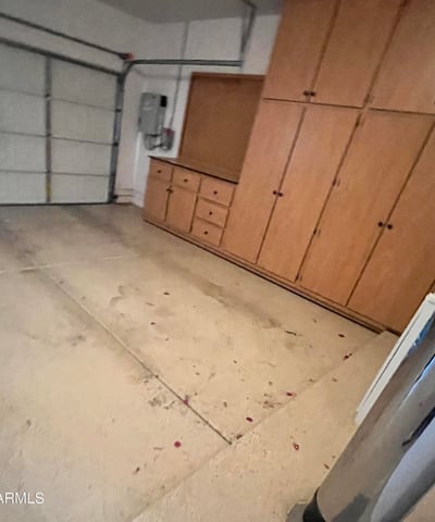Two-car garage with extensive custom storage cabinets, built-in work area, and generous space for vehicles, tools, and recreational equipment, making organization simple and efficient.
