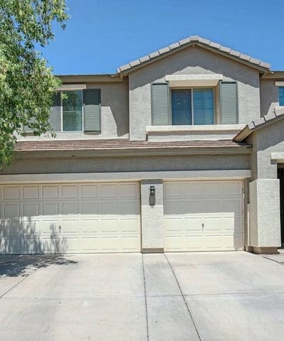 Welcoming front fa ade with desert landscaping, covered entry, and an oversized 3-car garage. This attractive exterior sets the stage for the beautifully renovated interior.