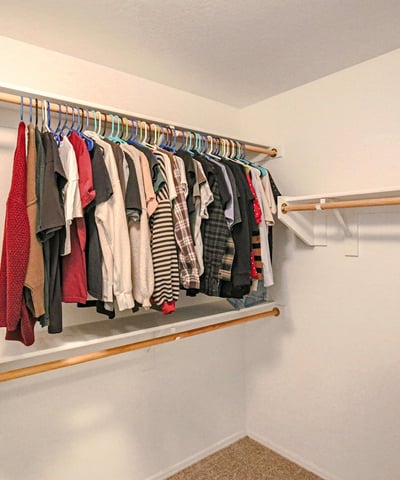 Spacious secondary walk-in closet featuring ample hanging space and flexible storage options, offering exceptional organization within the primary suite of this Waddell home.