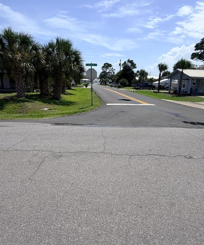 Vacant lot in a welcoming neighborhood, ready for your dream home near scenic palm trees.