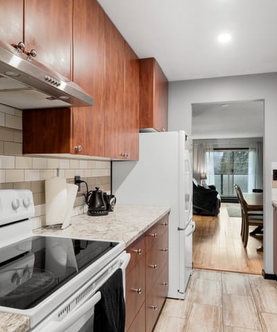 Modern kitchen featuring ample cabinet space, stainless steel appliances, and a seamless flow to the living area.