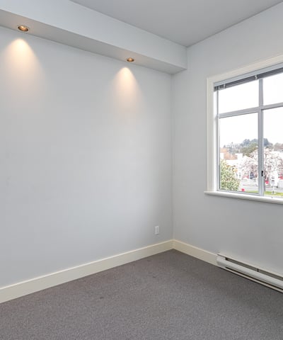 Bright, versatile room with natural light, perfect for a home office or creative space.
