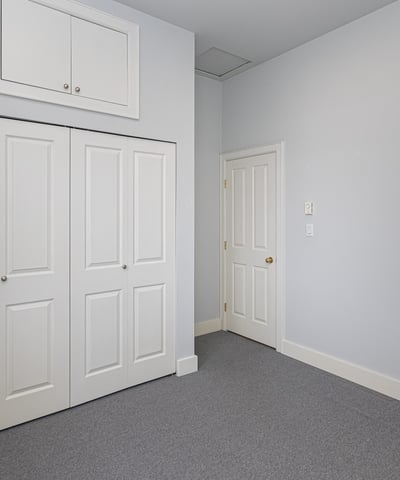 Bright, spacious room featuring built-in storage and a versatile layout, perfect for various living arrangements.