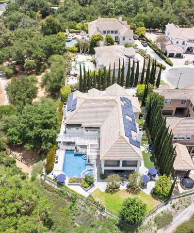 Stunning aerial view showcasing a spacious property with luxurious outdoor amenities and lush landscaping.
