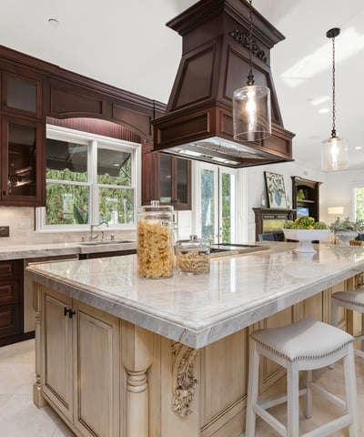 Spacious kitchen featuring a central island, modern appliances, and abundant natural light from large windows.