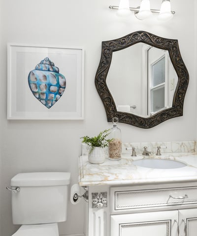 En-Suite Bathroom for Bedroom 1 
Bright bathroom featuring a decorative mirror, modern fixtures, and unique artwork, enhancing its inviting atmosphere and private direct access door to backyard