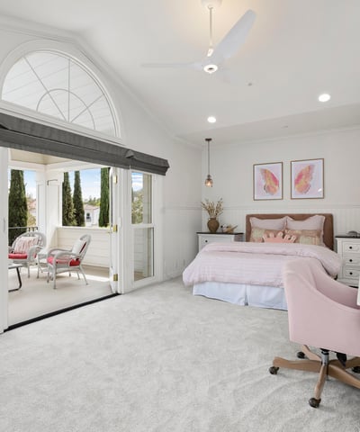 Bedroom 4-Bright and airy bedroom featuring a cozy sitting area, large windows, and modern furnishings with direct access to you own private front balcony.
